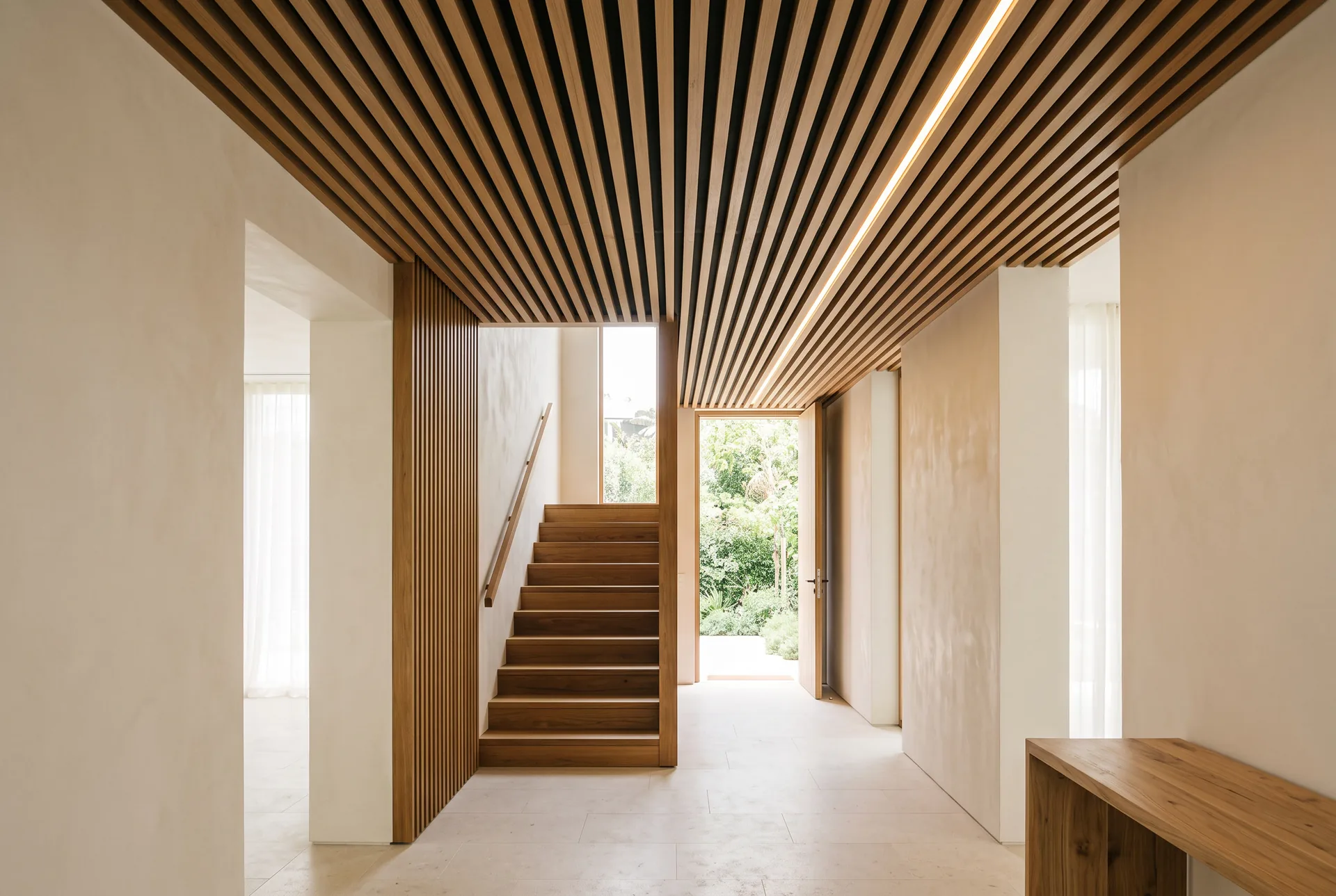 Slatted teak ceiling concept turning down the wall as a vertical slat return beside a staircase
